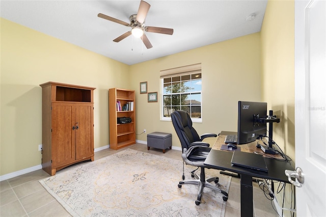 tiled home office featuring ceiling fan