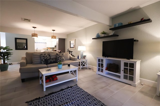 living room featuring beamed ceiling