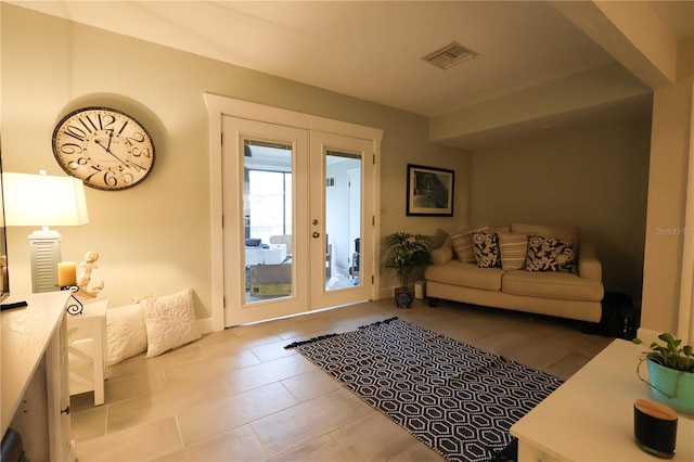 entryway featuring light tile patterned floors and french doors