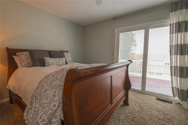 bedroom with access to outside, ceiling fan, and dark colored carpet