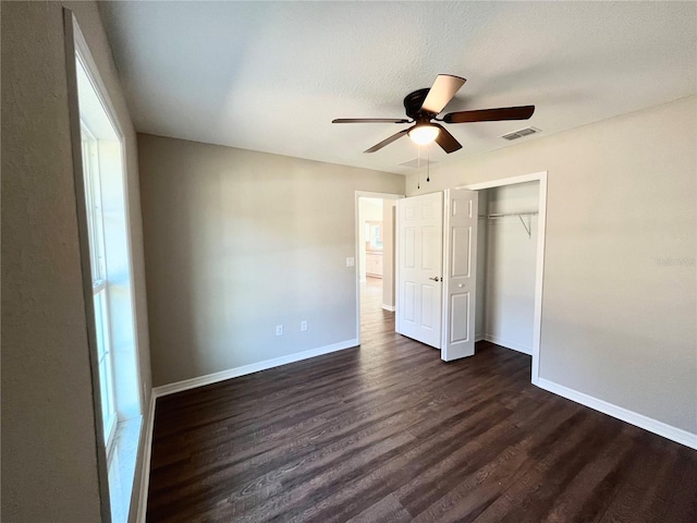 unfurnished bedroom featuring ceiling fan, a closet, and dark hardwood / wood-style floors