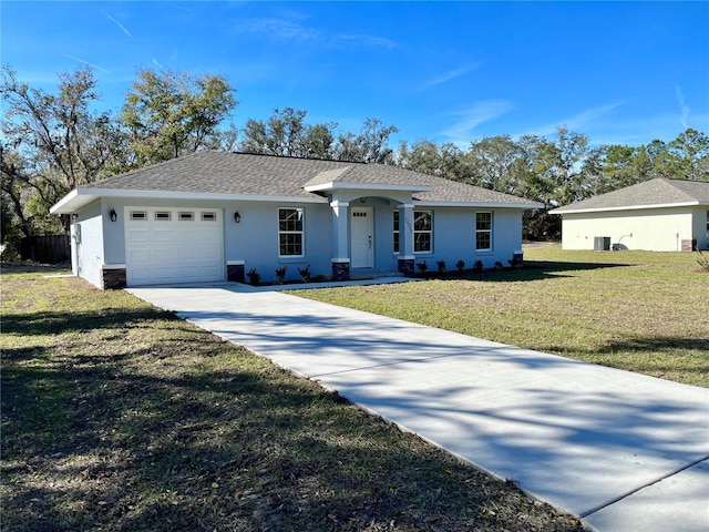 single story home with a front yard and a garage