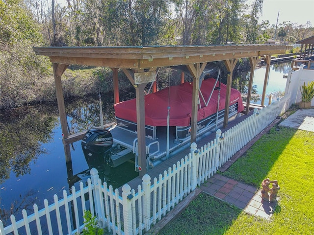 view of dock featuring a water view and a yard