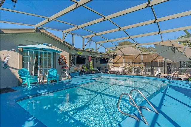 view of swimming pool featuring a patio and glass enclosure