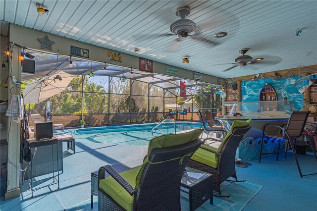 view of pool with a patio area, ceiling fan, and glass enclosure