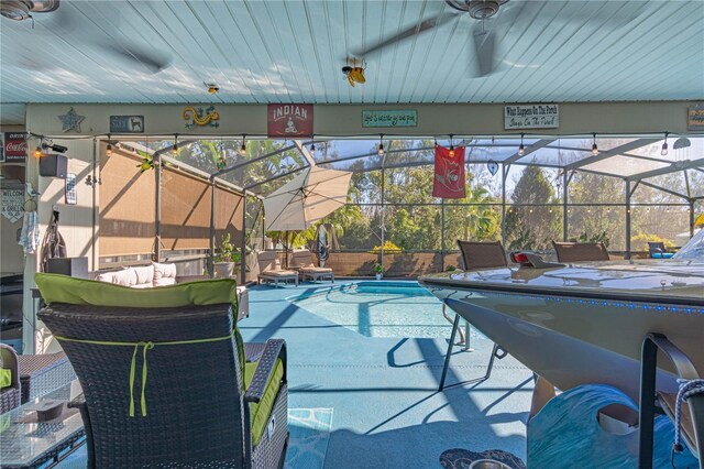 view of pool featuring a lanai and ceiling fan