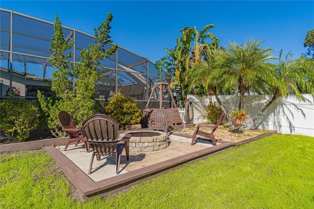 exterior space with an outdoor fire pit, a lanai, and a patio