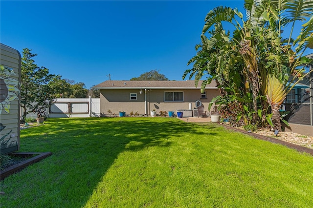 rear view of property with a lawn