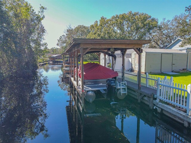 dock area featuring a water view and a lawn