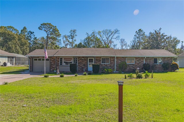 ranch-style home featuring a garage and a front yard