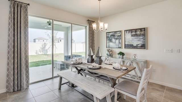 tiled dining room with a chandelier