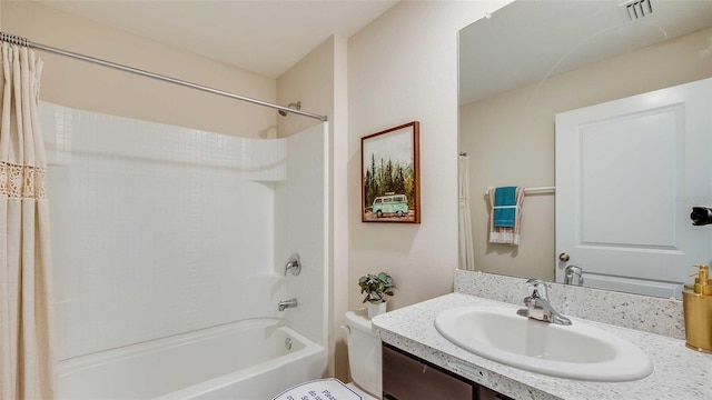 full bathroom with shower / bath combo with shower curtain, toilet, and vanity