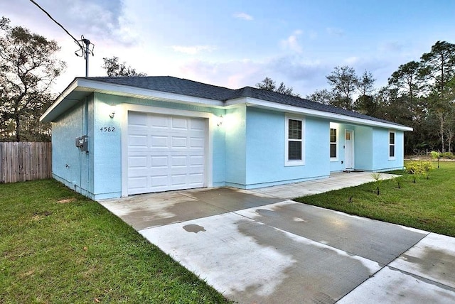 ranch-style home featuring a garage and a front yard