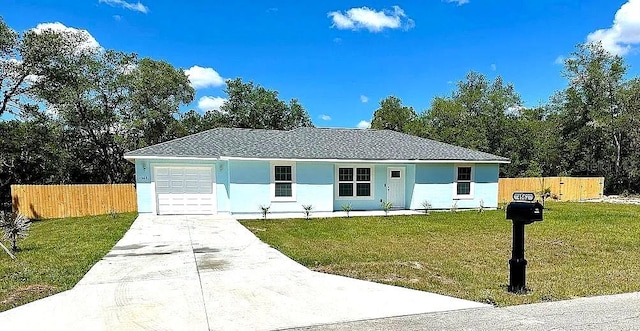 ranch-style house featuring a garage and a front yard