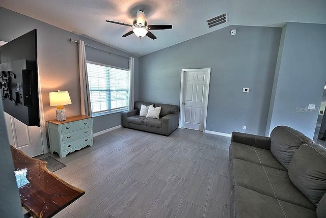 living room with ceiling fan and vaulted ceiling