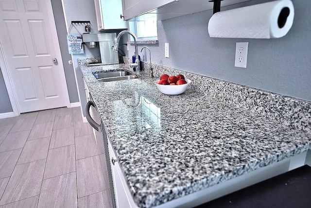 kitchen with sink and light stone countertops