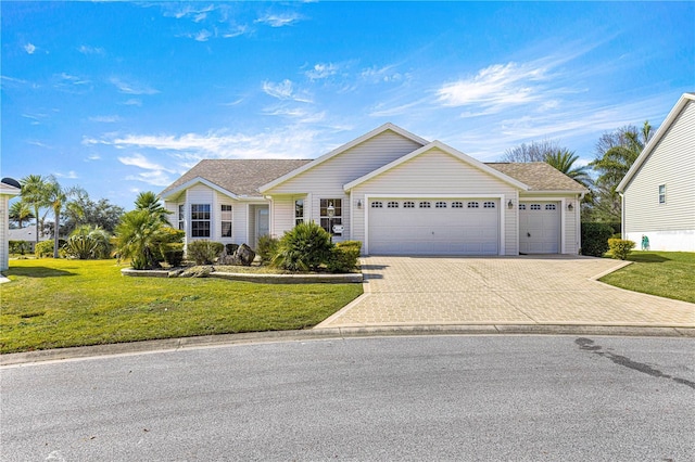 view of front of property featuring a garage and a front yard