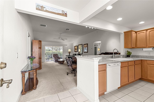 kitchen with kitchen peninsula, sink, light colored carpet, ceiling fan, and white dishwasher