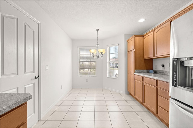 kitchen with decorative light fixtures, stainless steel fridge with ice dispenser, a textured ceiling, light tile patterned floors, and a notable chandelier