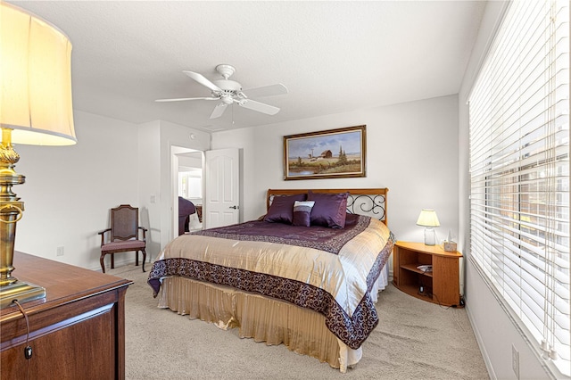 carpeted bedroom featuring a textured ceiling and ceiling fan