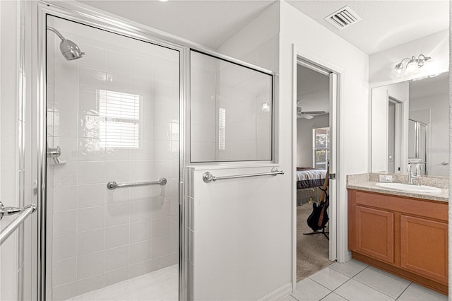 bathroom featuring vanity, an enclosed shower, and tile patterned floors