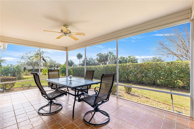 sunroom featuring ceiling fan