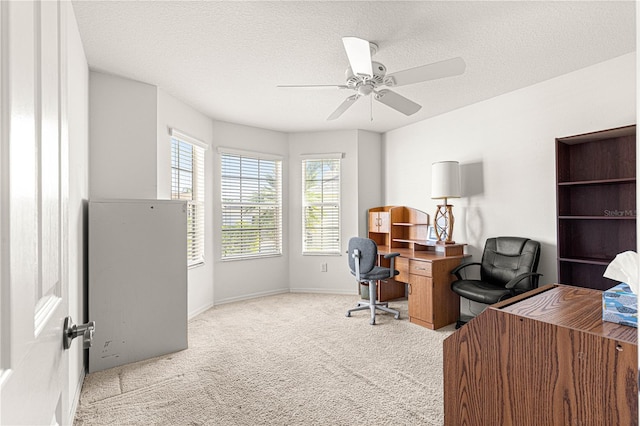 office area with ceiling fan, light colored carpet, and a textured ceiling