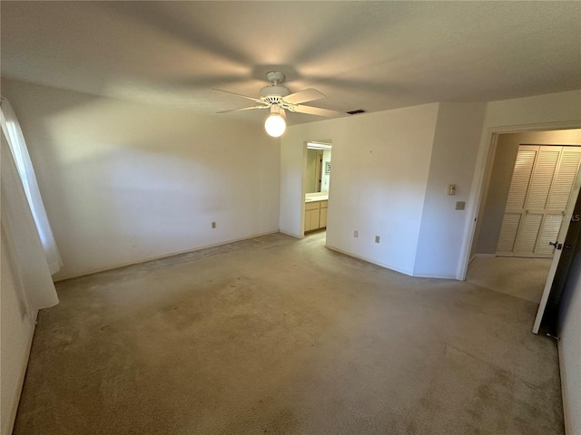 empty room with light carpet and ceiling fan