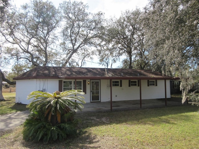 rear view of property featuring a yard