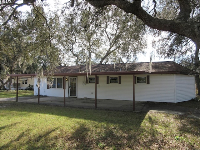 view of front of house featuring a front lawn and a patio area