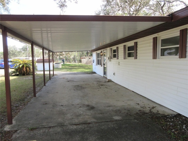 view of patio / terrace with a storage shed and a carport