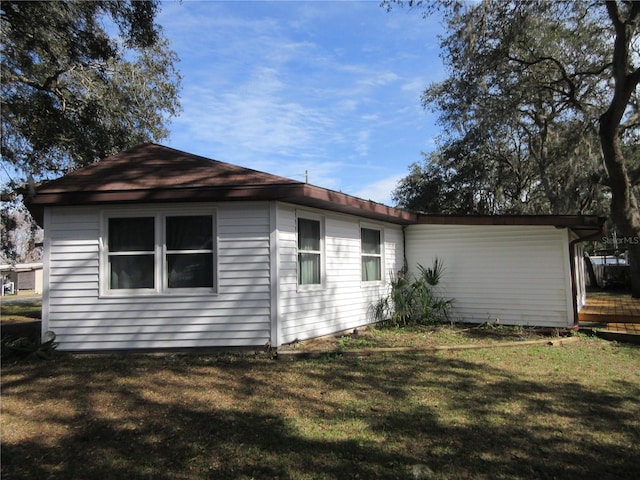 view of property exterior with a yard