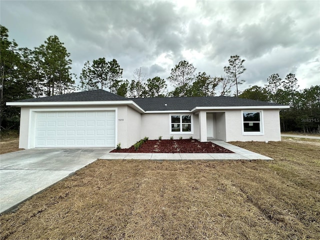 single story home with a front yard and a garage