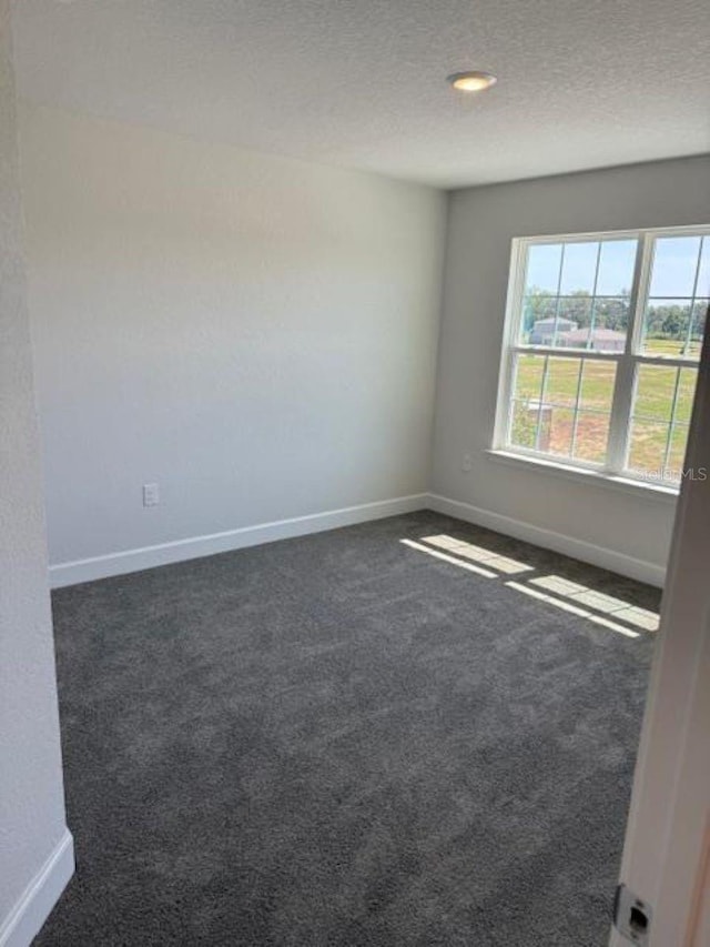 2210 NW 23rd Loop, Ocala, FL 34475 - empty room with carpet, baseboards, and a textured ceiling