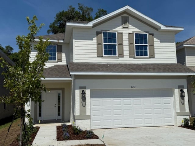 2214 NW 23rd Loop, Ocala, FL 34475 - traditional home featuring roof with shingles, concrete driveway, and a garage