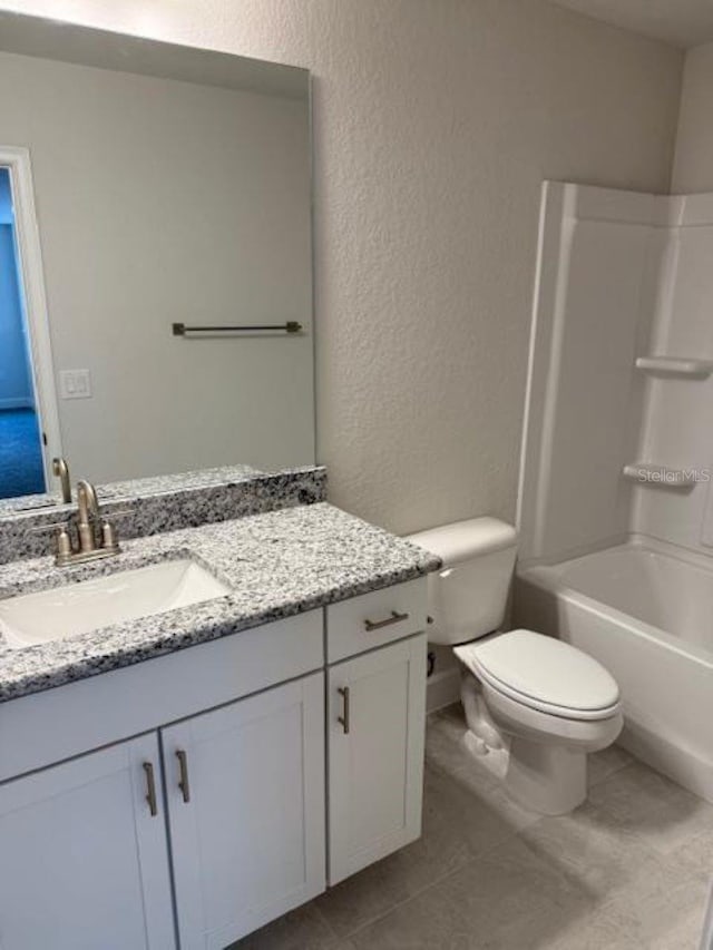 2214 NW 23rd Loop, Ocala, FL 34475 - bathroom with a textured wall, vanity, washtub / shower combination, and tile patterned floors