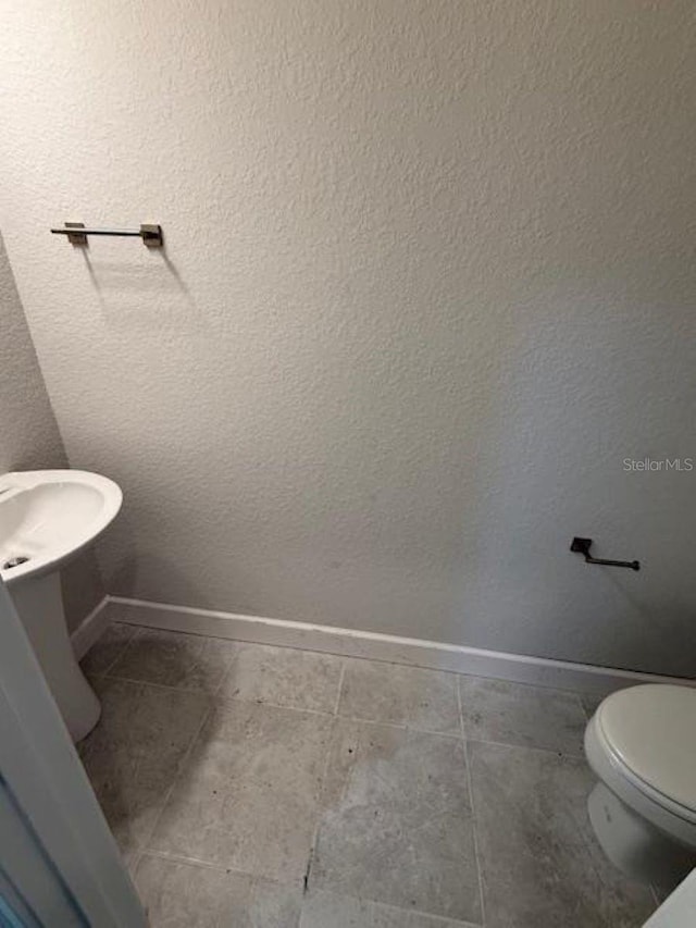 2214 NW 23rd Loop, Ocala, FL 34475 - half bath with baseboards and toilet