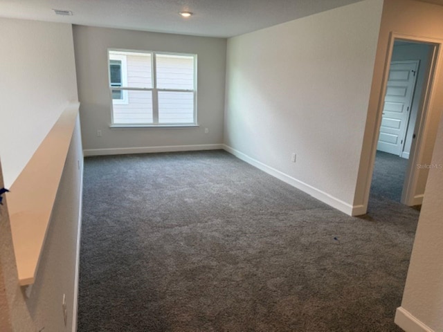 2214 NW 23rd Loop, Ocala, FL 34475 - unfurnished room featuring dark colored carpet and baseboards