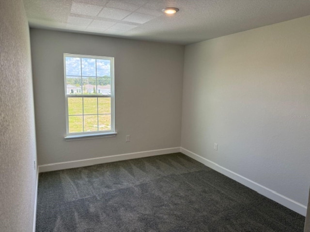 2214 NW 23rd Loop, Ocala, FL 34475 - spare room featuring dark colored carpet and baseboards