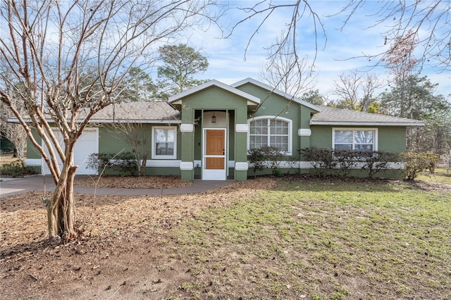 ranch-style home featuring a front lawn and a garage