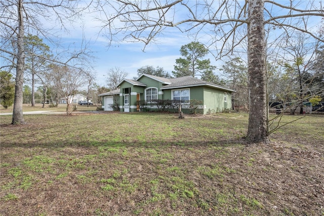 view of front of home featuring a front lawn and a garage