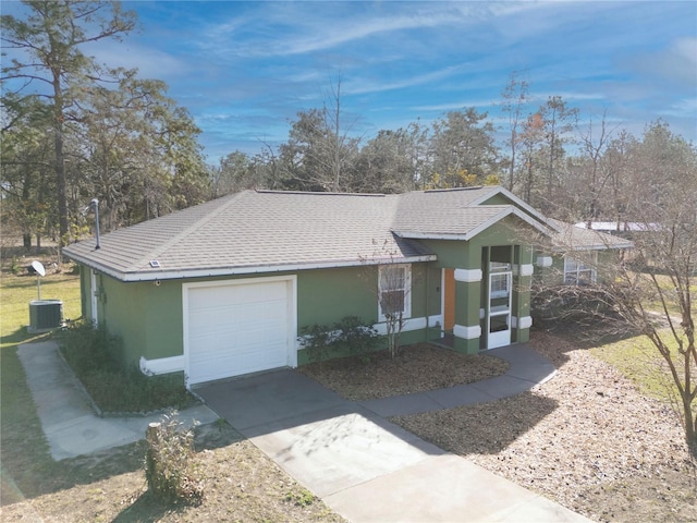 ranch-style home featuring central AC and a garage