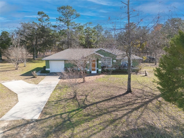 single story home featuring a front yard and a garage