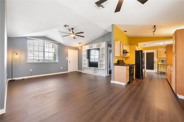 unfurnished living room featuring ceiling fan, dark hardwood / wood-style floors, and vaulted ceiling