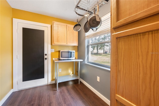 kitchen featuring light brown cabinets, dark hardwood / wood-style floors, and a textured ceiling