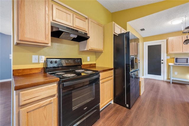 kitchen featuring light brown cabinetry, a textured ceiling, black appliances, and wood counters