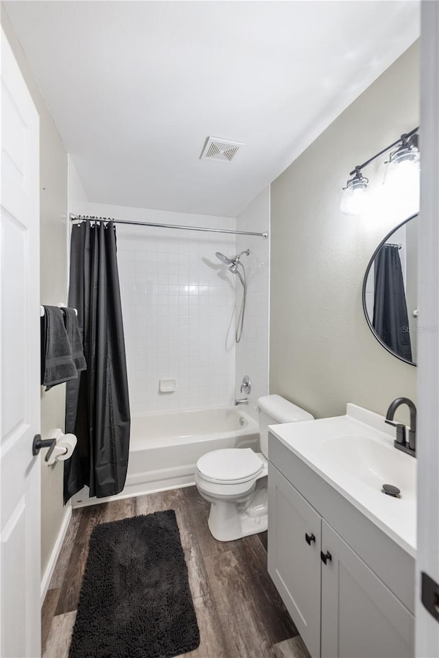 full bathroom featuring wood-type flooring, toilet, vanity, and shower / bathtub combination with curtain