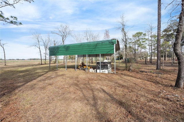 view of outbuilding featuring a rural view and a carport