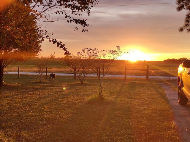 yard at dusk with a rural view