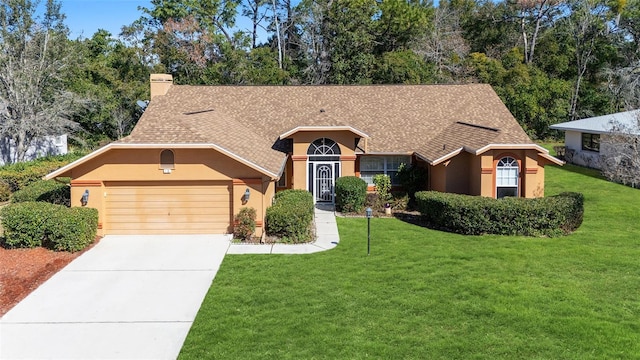 view of front of home with a garage and a front yard